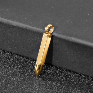 Close-up of a polished gold bullet pendant necklace with high-gloss metallic finish