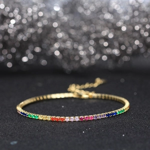 Macro shot of 2mm rainbow tennis bracelet with colorful crystals and adjustable gold chain