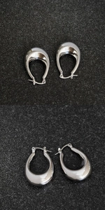 Detailed views of polished silver C-shaped teardrop earrings with a glossy metallic finish