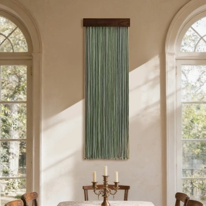 Minimalist sage green tassel wall hanging with dark brown wooden beam for home decor