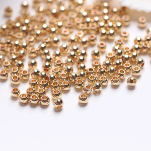 Macro shot of 14k gold-filled solid round spacer beads for DIY jewelry making