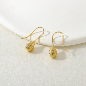 Macro view of golden water-drop earrings with exquisite horizontal texture lines