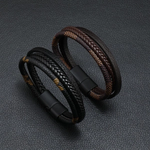 Detail view of black and brown braided leather bracelets with secure magnetic clasps