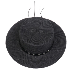 Detail of black flat-top straw hat with star-studded leather band and woven texture