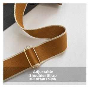 Detail of adjustable woven canvas strap in brown and white with golden metal buckle