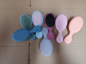 Macro view of colorful mini air cushion hairbrushes with round-tipped massage bristles