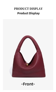 Detail view of woven leather texture on dark burgundy hobo bag with gold metal buckle
