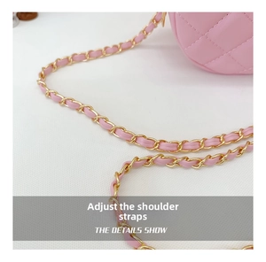 Detailed macro view showing the adjustable shoulder strap and gold chain of the pink bag