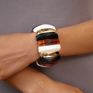 Detailed view of chunky multi-color geometric acrylic bangles with elastic stretch design