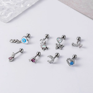 Detail of surgical steel cartilage studs featuring blue heart zircon and butterfly designs