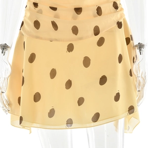 Detailed view of yellow polka dot chiffon fabric with elegant ruffled waist and A-line cut