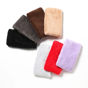 Close-up showing seven colors of soft coral fleece neck warmers in a tidy stack