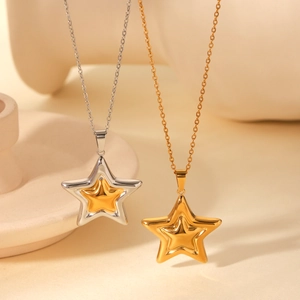 Detailed view of two-tone gold and silver star pendants on polished steel chains
