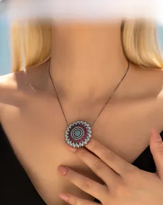 Macro shot of S925 silver sunflower pendant with blue crystals and vintage black chain