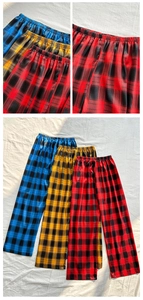 Detail of elastic waistband and soft plaid fabric texture on loose home sleep pants