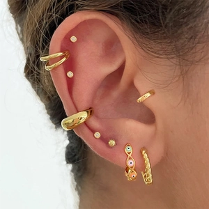 Close-up of gold S925 sterling silver earrings with colorful evil eye enamel and zircons