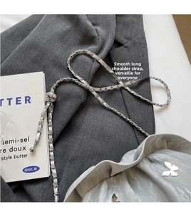 Detail of silver pleated cloud bag with metallic chain and sphere adjustment buckle