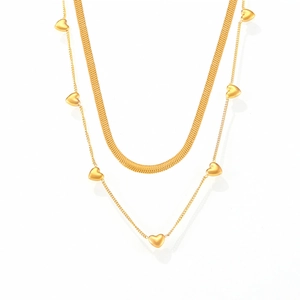 Layered gold necklace featuring a flat snake chain and 3D heart charms on a white background