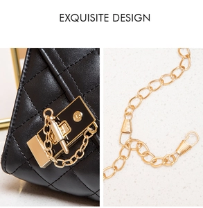Detailed view of black quilted faux leather handbag with golden mechanical lock and chain
