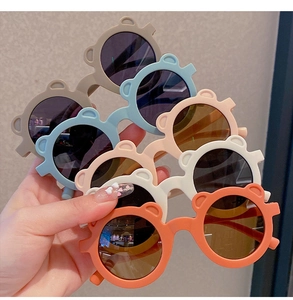 Detailed view of matte bear-ear kids sunglasses in six colors with round dark lenses