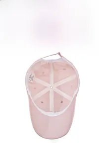 Detail view of pink cotton baseball cap interior with sweatband and adjustable buckle