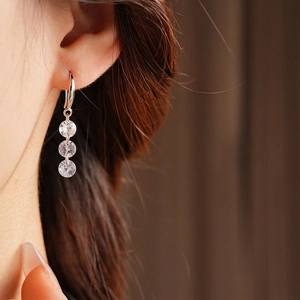 Minimalist silver earrings with three round zircons in a dangling drop hook design