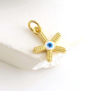Detailed macro of gold-plated evil eye star charm with blue zircon for jewelry making