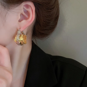 Double-layered two-tone crinkled texture hoop earrings shown on model side profile