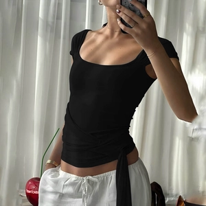Detail of black square neck crop top featuring sexy criss-cross back straps and waist ties