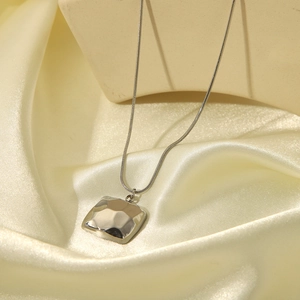 Silver minimalist snake chain necklace with square hammered texture pendant on silk