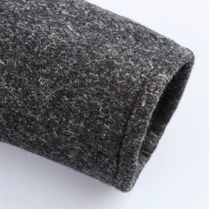 Close-up of the thick wool blend texture and stitching detail on the dark grey coat cuff