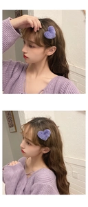 Close-up of a purple plush heart hair clip worn as a side accessory for women