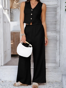 Detail of black vest and wide-leg pants set featuring elegant lace side trim for women