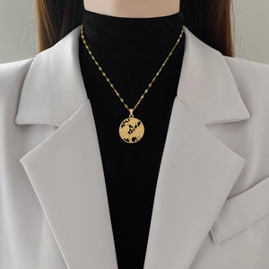 Elegant gold titanium steel necklace with sparkling crystal tree of life pendant on model