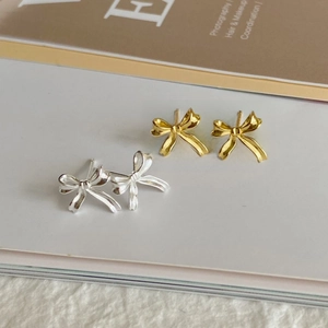 Irregular bow-knot stud earrings in gold and silver finish with smooth mirror-like luster