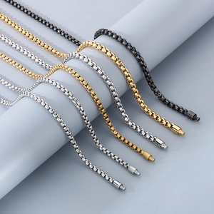 Detail showing box chain necklaces in gold, silver and black stainless steel options
