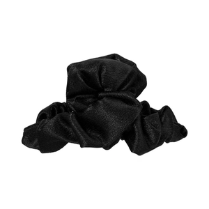Detailed view of the black ruffled fabric texture with subtle glitter on the hair claw clip