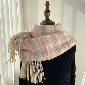 Rainbow plaid winter scarf with tassels shown on mannequin over a black knit sweater