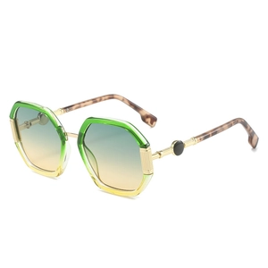 Fashionable octagonal geometric sunglasses with green-to-yellow gradient lenses and gold temples