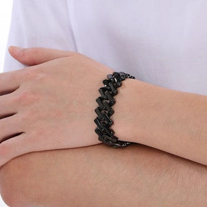 Close-up of black 20mm stainless steel Cuban link bracelet on a male wrist