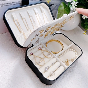 Black leather jewelry box with velvet lining and multi-compartment storage organizer