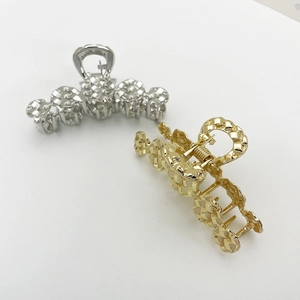 Braided texture alloy hair claws in gold and silver finish on white background