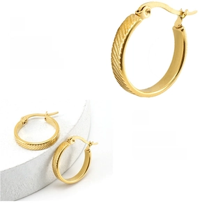 Close-up of golden hoop earrings featuring diagonal striped texture and high-polished finish