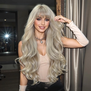 Close-up of long wavy platinum blonde wig with flat bangs and soft synthetic fibers