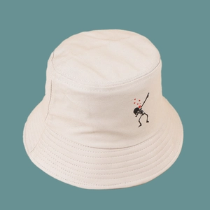 Detail of beige cotton bucket hat with dabbing skeleton and heart embroidery