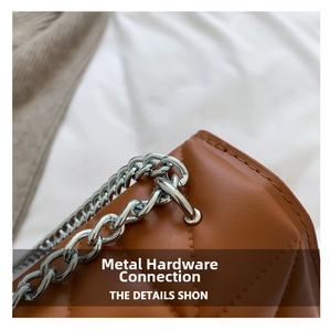 Close-up of brown quilted leather bag showing silver chain hardware and stitching