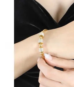 Detail of 18K gold plated stainless steel snake chain bracelet with pavé zircon beads