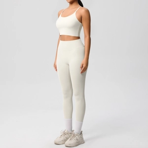 Detailed side view of white high-stretch yoga set with thin straps and high-waist leggings