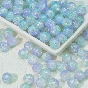 Macro shot of 10mm blue-purple gradient glass beads with crackle texture for DIY jewelry