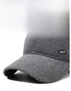 Close-up of gray waffle knit texture and Sport New Style emblem on earflap baseball cap